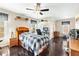 Comfortable bedroom with wood floors, ceiling fan, and desk near a bright window at 1302 Turtlebrook Ln, Lawrenceville, GA 30043