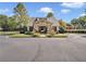 Charming stone and siding clubhouse with lush landscaping and parking area offers a welcoming community gathering spot at 1302 Turtlebrook Ln, Lawrenceville, GA 30043