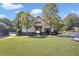 Community center on a lush lawn features tennis courts and a covered entrance with benches at 1302 Turtlebrook Ln, Lawrenceville, GA 30043