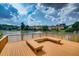 Spacious deck with seating area overlooking the lake provides a perfect spot to enjoy the serene views at 1302 Turtlebrook Ln, Lawrenceville, GA 30043