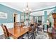 Formal dining room featuring wainscoting, a chandelier, and hardwood floors, perfect for gatherings at 1302 Turtlebrook Ln, Lawrenceville, GA 30043