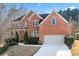 Charming two-story brick home with attached garage and beautifully landscaped front yard at 1302 Turtlebrook Ln, Lawrenceville, GA 30043