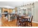Eat-in kitchen area with wood floors, breakfast bar, and wood dining table at 1302 Turtlebrook Ln, Lawrenceville, GA 30043