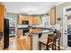 Well-lit kitchen featuring wood cabinets, granite countertops, and modern appliances at 1302 Turtlebrook Ln, Lawrenceville, GA 30043