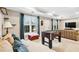 Spacious living room featuring plush couches, a foosball table and natural light from windows at 1302 Turtlebrook Ln, Lawrenceville, GA 30043