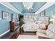 Elegant primary bedroom with tray ceiling, natural light, and hardwood floors at 1302 Turtlebrook Ln, Lawrenceville, GA 30043