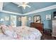 Elegant primary bedroom featuring tray ceiling, hardwood floors, and ensuite access at 1302 Turtlebrook Ln, Lawrenceville, GA 30043