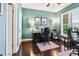 Spacious office with hardwood floors, natural light, and a dark desk at 1302 Turtlebrook Ln, Lawrenceville, GA 30043