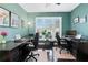 Home office featuring hardwood floors, natural light, and two black office chairs at 1302 Turtlebrook Ln, Lawrenceville, GA 30043