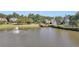 Picturesque pond with fountain and sitting areas, perfect for relaxation and enjoying the view of the surrounding homes at 1302 Turtlebrook Ln, Lawrenceville, GA 30043