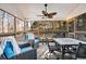 Relaxing screened porch with comfortable seating and a ceiling fan for outdoor enjoyment at 1302 Turtlebrook Ln, Lawrenceville, GA 30043
