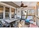 Inviting screened porch with dining and lounge areas, perfect for entertaining or relaxing outdoors at 1302 Turtlebrook Ln, Lawrenceville, GA 30043