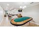 Recreation room featuring a poker table, bar area, and comfortable seating in the background at 1302 Turtlebrook Ln, Lawrenceville, GA 30043
