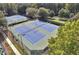 Overhead view of community tennis courts with well-maintained surfaces and surrounded by lush trees at 1302 Turtlebrook Ln, Lawrenceville, GA 30043