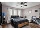 Spacious bedroom with a built-in workspace and ceiling fan at 2251 Pernoshal Ct, Atlanta, GA 30338