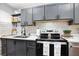 Updated kitchen featuring gray cabinets, quartz countertops, and stainless steel appliances at 2251 Pernoshal Ct, Atlanta, GA 30338