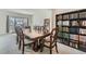 Large dining room features hardwood table with seating for 8 and bookshelf at 10965 Glenbarr Dr, Johns Creek, GA 30097