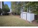 Exterior shot of the backyard featuring a storage shed, mature trees, and a gazebo at 296 Cedar Bay Cir, Dallas, GA 30157