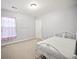 Minimalist bedroom featuring soft gray walls and a simple white metal bed frame at 296 Cedar Bay Cir, Dallas, GA 30157