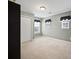 Bedroom with neutral carpet and gray walls, two windows with black curtains and white closet doors at 296 Cedar Bay Cir, Dallas, GA 30157