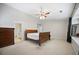 Bright bedroom with neutral walls, carpet flooring, ceiling fan, and a classic wood sleigh bed at 296 Cedar Bay Cir, Dallas, GA 30157