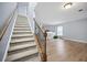 Inviting entryway featuring wood floors, staircase with wood and iron, and freshly painted walls at 296 Cedar Bay Cir, Dallas, GA 30157