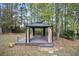 View of the gazebo sitting on a wooden deck in the backyard with neutral-colored privacy curtains at 296 Cedar Bay Cir, Dallas, GA 30157