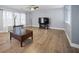 A cozy living room with wood floors, a large TV, and lots of natural light at 296 Cedar Bay Cir, Dallas, GA 30157