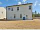 View of rear of home with lawn at 7889 Winkman Dr, Fairburn, GA 30213