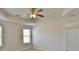 Main bedroom features a ceiling fan, neutral walls, and an en-suite bathroom at 7889 Winkman Dr, Fairburn, GA 30213