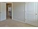 View of carpeted bedroom with white doors and casing at 7889 Winkman Dr, Fairburn, GA 30213