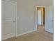 View of carpeted bedroom with white doors and casing at 7889 Winkman Dr, Fairburn, GA 30213