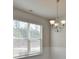 Dining Room with natural light, chandelier, and decorative wainscoting at 7889 Winkman Dr, Fairburn, GA 30213