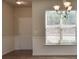 Dining Room with natural light, chandelier, and decorative wainscoting near entryway at 7889 Winkman Dr, Fairburn, GA 30213