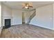 Spacious living room features wood flooring, a fireplace, and a staircase leading to the upper level at 7889 Winkman Dr, Fairburn, GA 30213