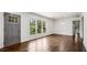 Bright living room with hardwood floors, a large window, and modern light fixture at 1893 Windsor Sw Dr, Atlanta, GA 30311