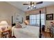 Cozy bedroom featuring a four-poster bed, ceiling fan, and window at 1965 Nocturne Dr # 1205A, Alpharetta, GA 30009