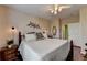 A spacious bedroom with a bed, side table, and ceiling fan at 1965 Nocturne Dr # 1205A, Alpharetta, GA 30009