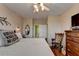 Bedroom featuring a bed, dresser, TV and ceiling fan at 1965 Nocturne Dr # 1205A, Alpharetta, GA 30009
