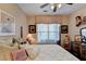 A well-lit bedroom showcases a bed, ceiling fan, and decor at 1965 Nocturne Dr # 1205A, Alpharetta, GA 30009