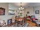 Dining room with wood floor, modern light fixture, and view of the kitchen at 1965 Nocturne Dr # 1205A, Alpharetta, GA 30009