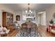 Dining room with wood floor, modern light fixture, and view of the kitchen at 1965 Nocturne Dr # 1205A, Alpharetta, GA 30009