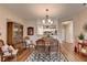 Dining room boasts an area rug, chandelier, and view of the kitchen and doorway at 1965 Nocturne Dr # 1205A, Alpharetta, GA 30009