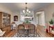 Dining room with wood floor, modern light fixture, and view of the kitchen at 1965 Nocturne Dr # 1205A, Alpharetta, GA 30009