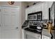 Stylish kitchen featuring stainless steel appliances and tiled backsplash at 1965 Nocturne Dr # 1205A, Alpharetta, GA 30009