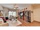 Comfortable living room with wood floors, ceiling fan, and custom built-ins at 1965 Nocturne Dr # 1205A, Alpharetta, GA 30009