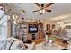 Spacious living room shows built-in shelving and a ceiling fan and connects to the kitchen at 1965 Nocturne Dr # 1205A, Alpharetta, GA 30009