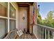 A cozy wooden patio with a bench, American flag, and peaceful view of the surrounding greenery at 1965 Nocturne Dr # 1205A, Alpharetta, GA 30009