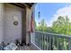 A cozy wooden patio with a bench, American flag, and peaceful view of the surrounding greenery at 1965 Nocturne Dr # 1205A, Alpharetta, GA 30009