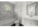 This renovated bathroom features stylish tile work, updated fixtures, and a tub-shower combination at 327 Thornton Sw St, Atlanta, GA 30315